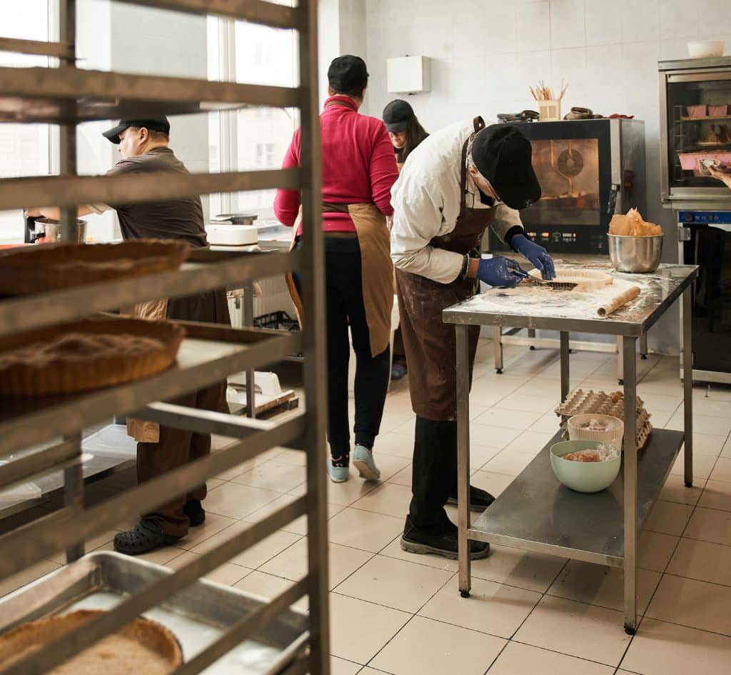 Restaurant chefs preparing meals in busy kitchen