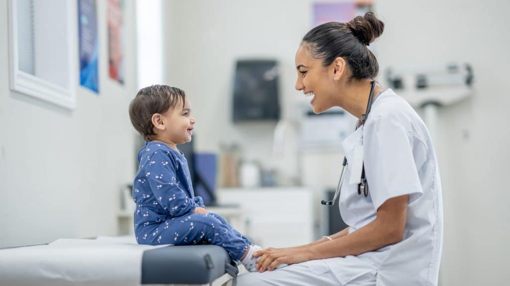 Caring nurse bringing joy to young patient