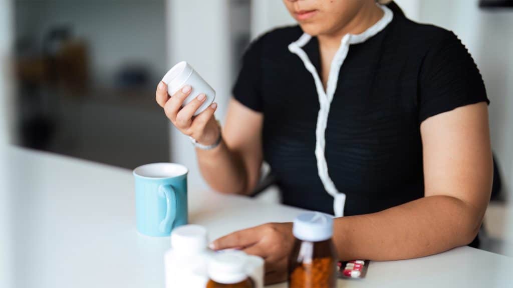 Woman reviewing prescription medications