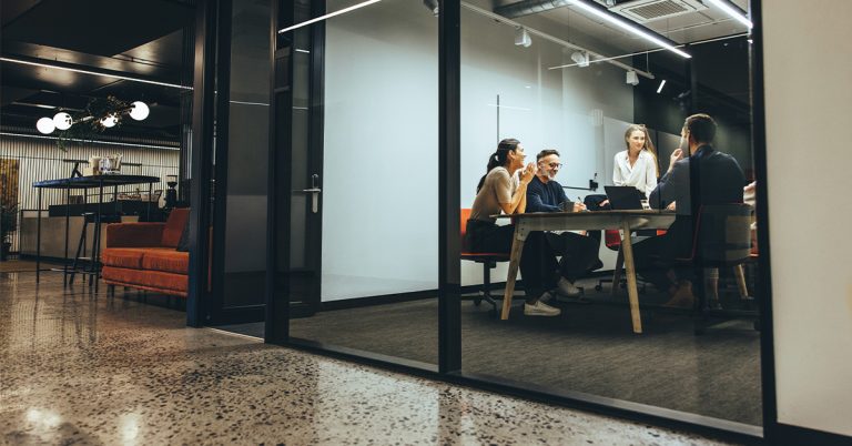 Conference room setting with professionals around conference table